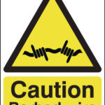 caution barbed wire sign